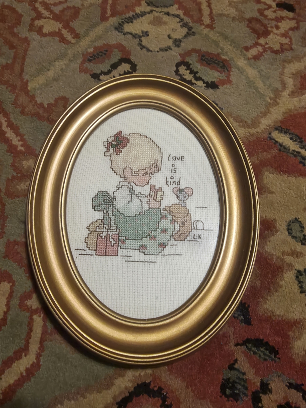 Gold Oval Framed Cross Stitch Artwork - 'Love is Kind'